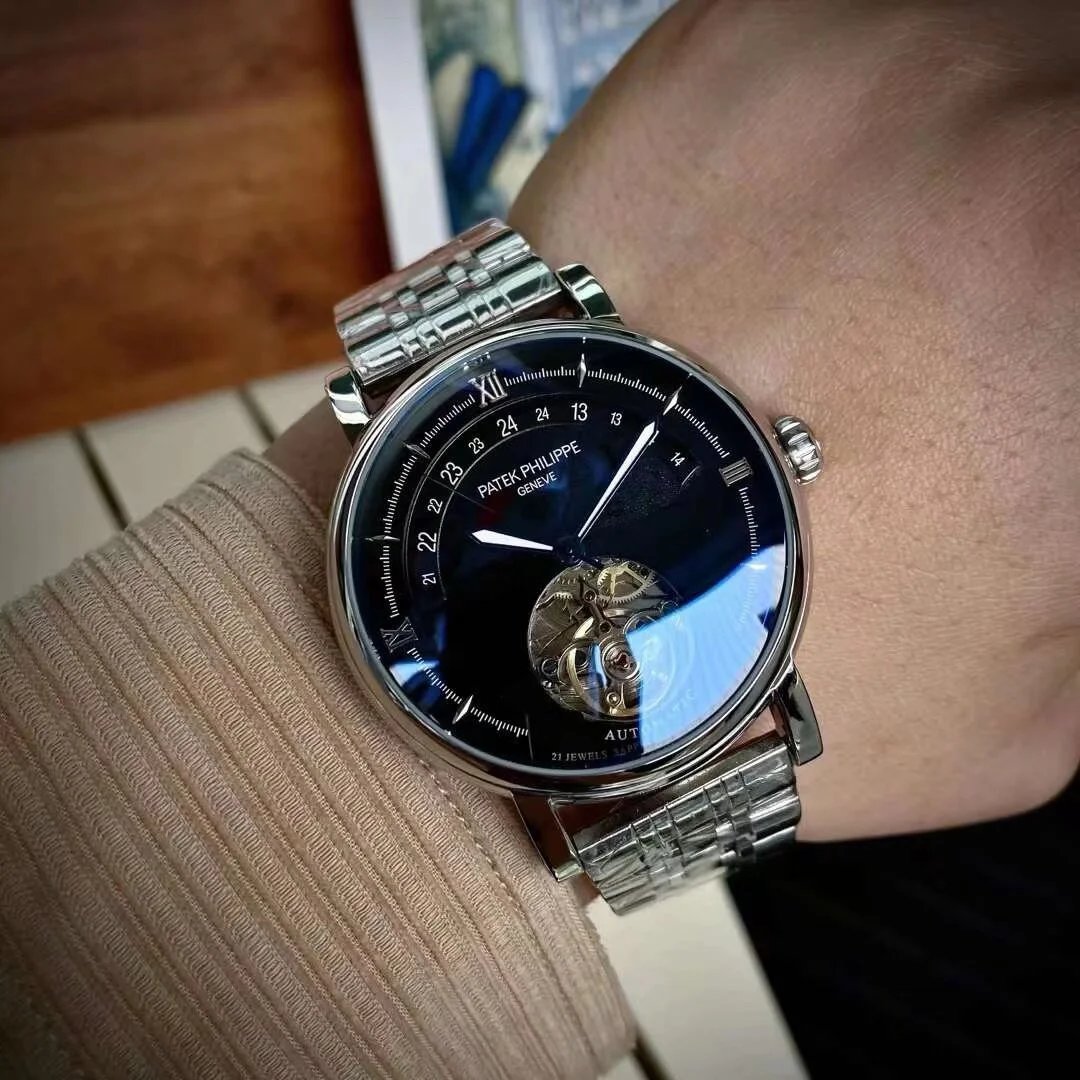 Close-up of a person wearing a luxury watch with a visible brand name.