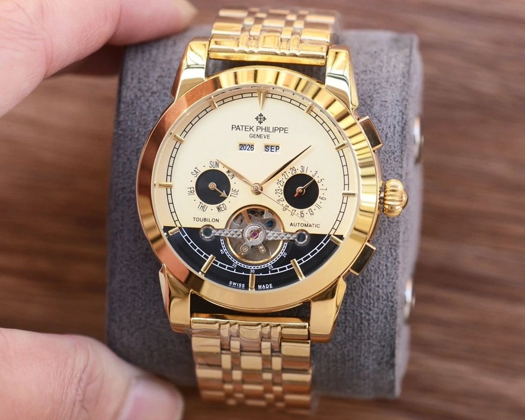 Gold Patek Philippe watch on a gray cushion with a blurred wooden background
