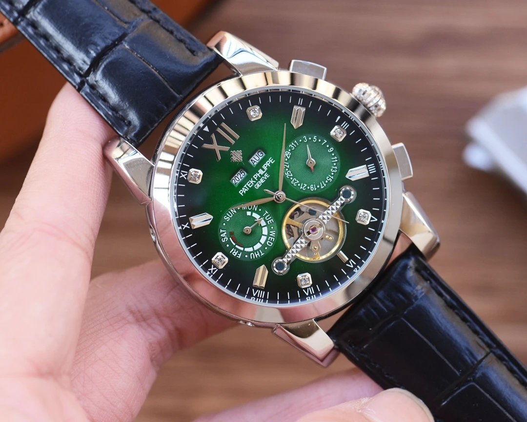 Green watch with black leather strap held by a hand