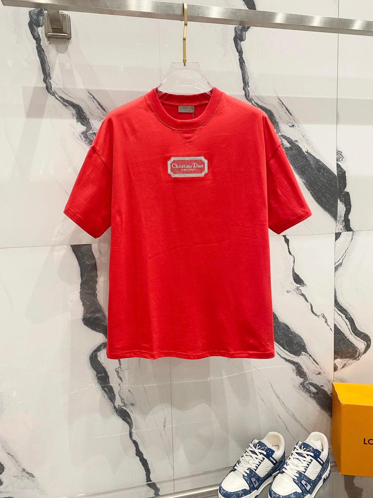 Red t-shirt with a logo on a marble background