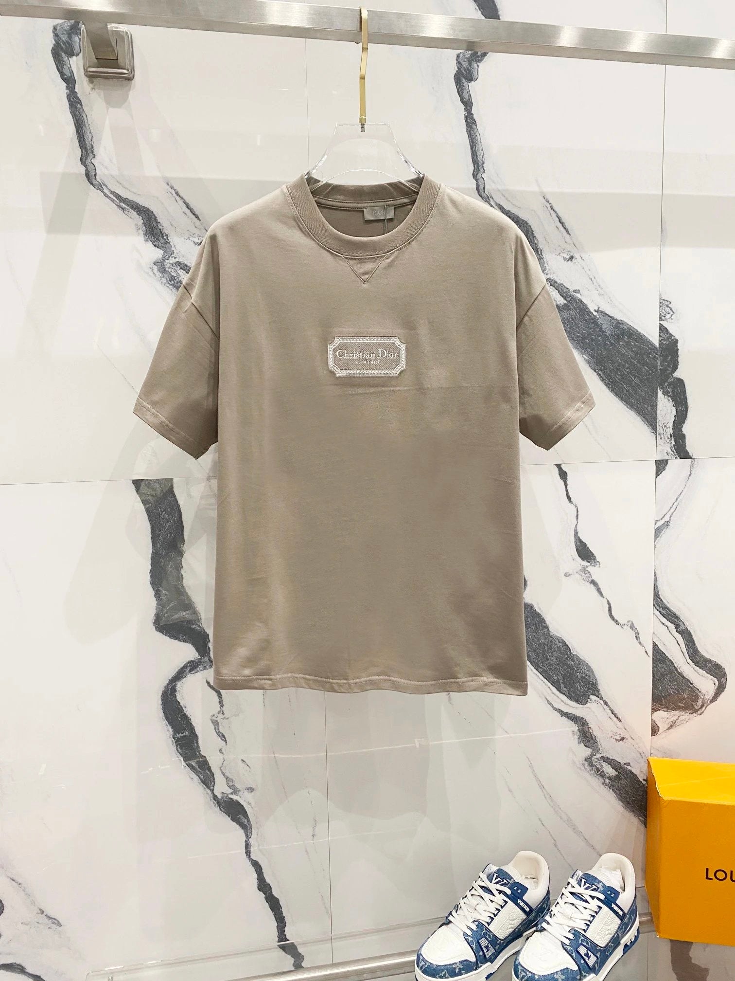 Beige t-shirt with a logo on a marble background