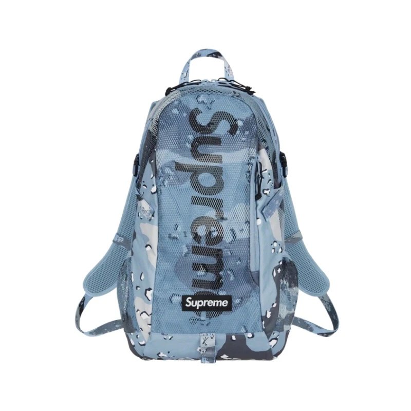 A light blue Supreme backpack with a water-droplet camouflage pattern and a large vertical Supreme logo on the front, shown against a plain white background.