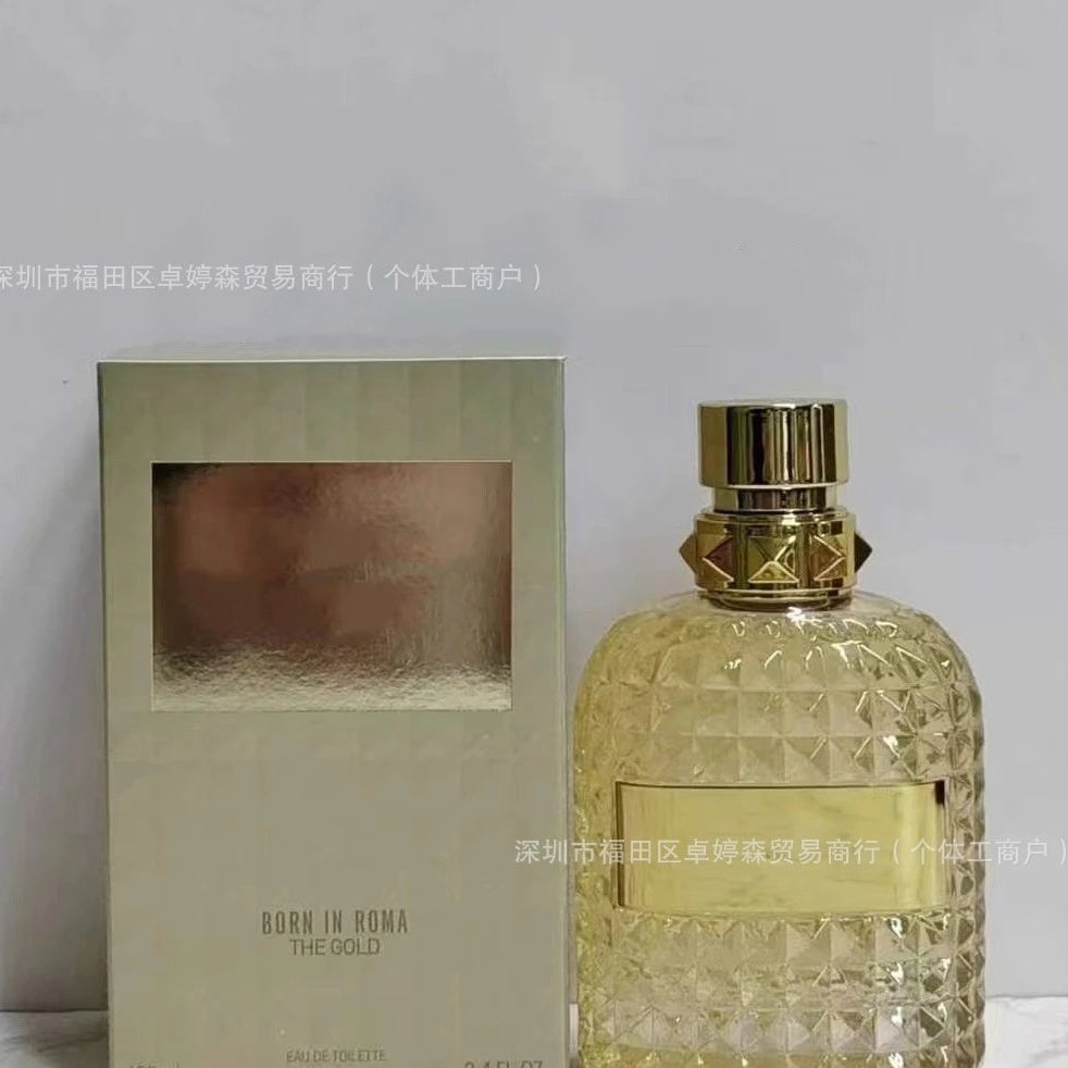 Gold perfume bottle and packaging on a light gray background