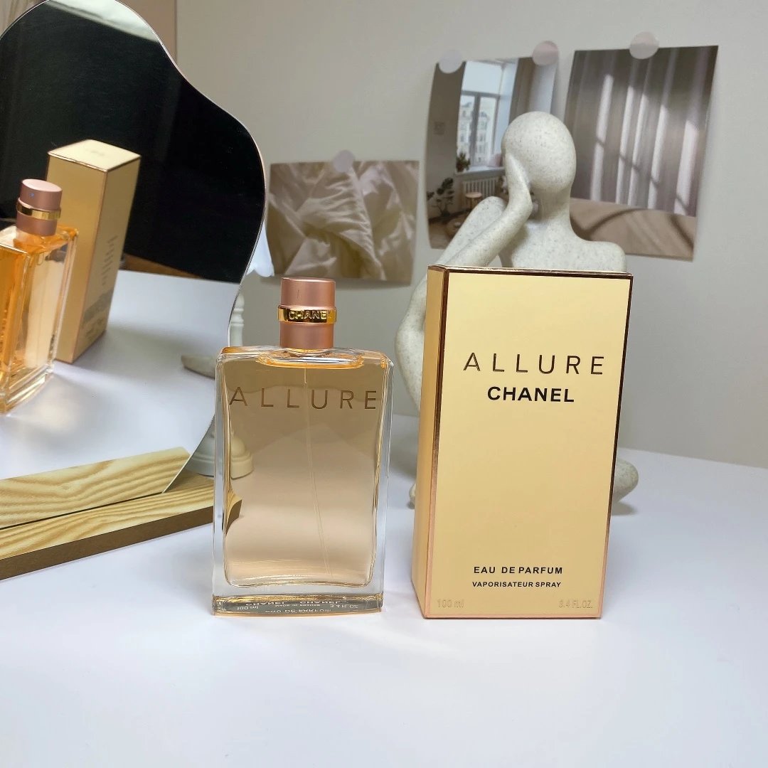 Chanel Allure perfume bottle and packaging on a white surface with a mirror in the background.
