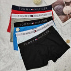 Set of Tommy Hilfiger underwear in various colors on a gray background