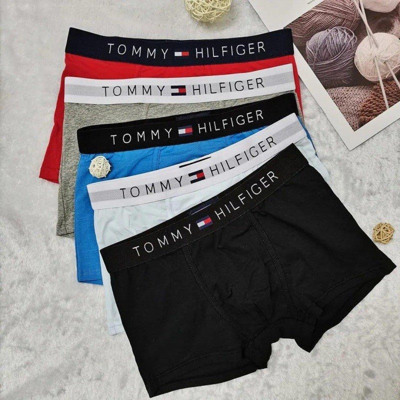 Set of Tommy Hilfiger underwear in various colors on a gray background