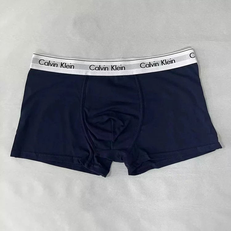 Navy Calvin Klein boxer briefs on a light gray background