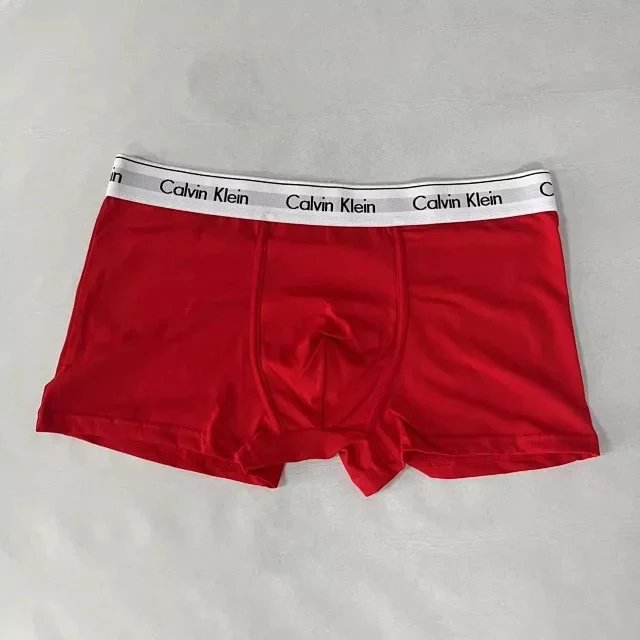 Red Calvin Klein boxer briefs on a gray background