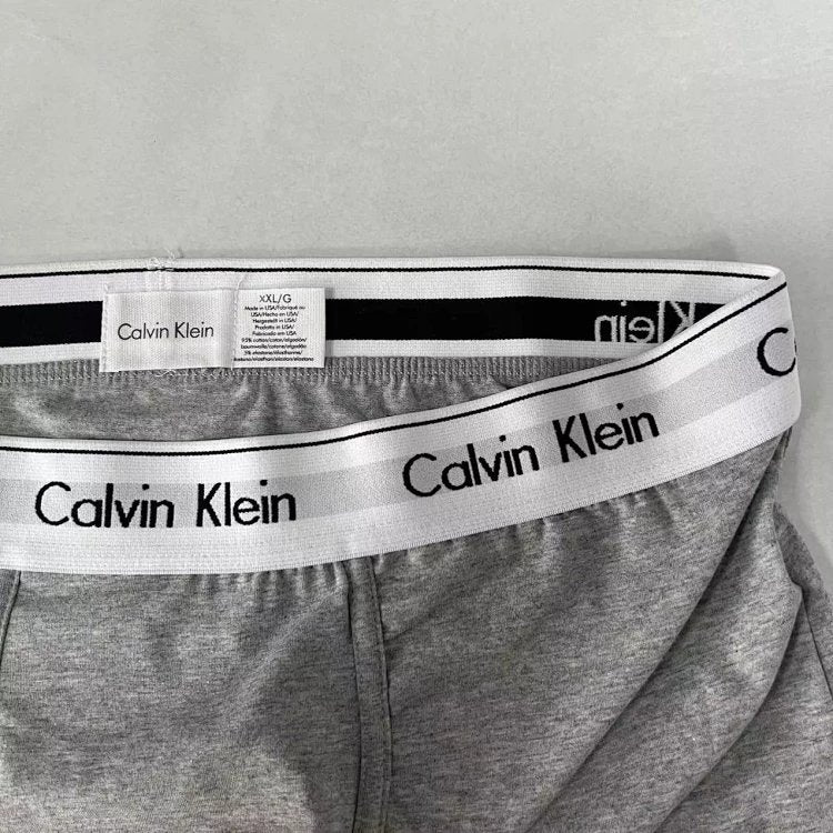 Gray Calvin Klein underwear with white waistband on a light gray background