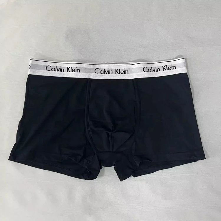 Black Calvin Klein boxer briefs on a gray background