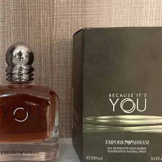 Emporio Armani perfume bottle and packaging on a textured surface