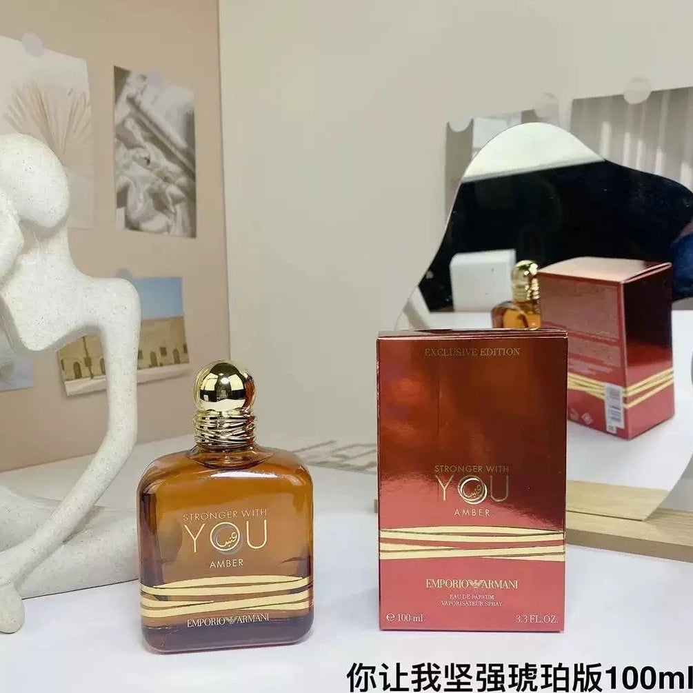 Perfume bottle and packaging on a table with decorative items in the background