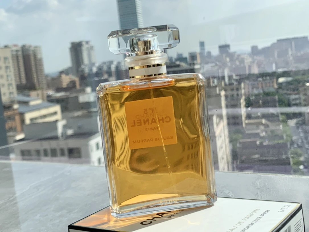 Chanel perfume bottle with a cityscape in the background