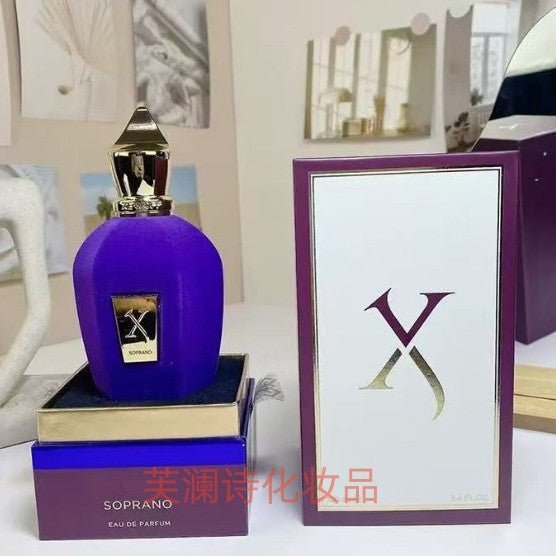 Purple perfume bottle with gold cap and 'X' logo next to its packaging on a white surface.